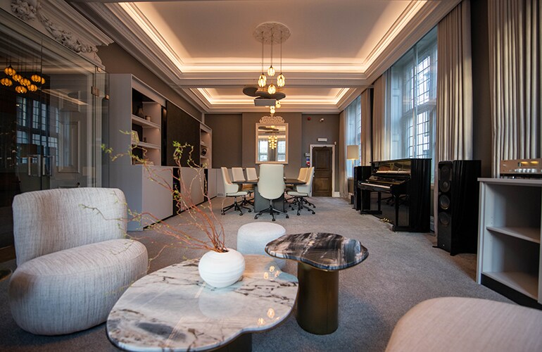London training facility lounge-style room with seating and presentation area.