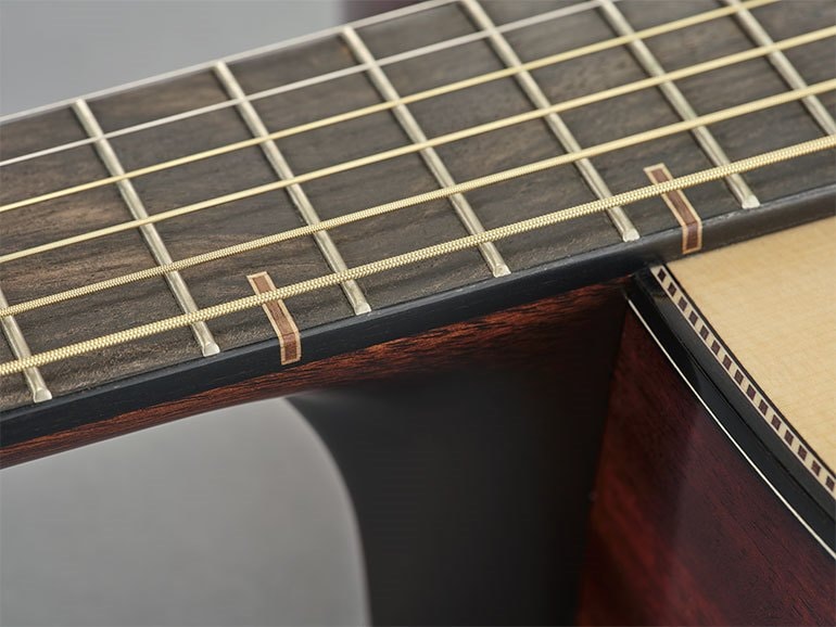 Close-up of the distinctive fingerboard inlay resembling traditional Japanese Kumiki woodworking